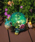 Garden Turtle Statue Outdoor Decor Resin Figurine with glass solar lights glowing on patio with UV protection and LED lights
