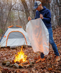 Man holding Emergency Fire Blanket 40 By 40 Inches, Woven Fiberglass Fire Shield For Smothering Small Area Fires Up To 900 Degrees Fahrenheit outdoors