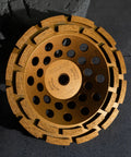 Top Tier Double Row Segmented Diamond Concrete Grinding Wheel For 4 1/2 Inch Angle Grinders 5/8-11 Arbor, golden surface, circular design.
