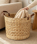 Large Water Hyacinth Storage Basket 15.7 Inch Woven Seagrass Bin with Sturdy Design being used for blanket storage