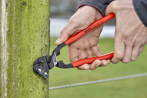 CoBolt Compact Bolt Cutter With Notched Blade For Heavy Duty Cutting Up To 0.170 Inch Diameter in action cutting wire on post