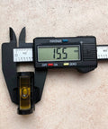 Front view of a digital caliper-style gunsmith level with yellow bubble vial and magnetic base, reading 15.5 mm