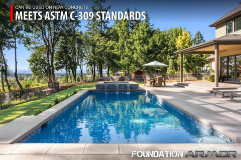 Outdoor pool area featuring a patio, trees, and water, showcasing Water Based Acrylic Concrete Sealer And Paver Protector With Cure And Seal Formula Low Gloss Guard 5 Gallon Barrel Hardcore Blend For Driveways Tough As Nails Finish.