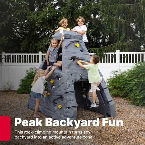 Four kids climbing on Skyward Summit Climbing Wall Playset For Kids Ages Four To Eight, 6.5 Ft Four Sided Rock Wall, Backyard Outdoor Playground.