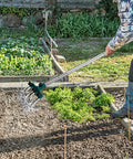 Person using Rotary Cultivator Garden Tiller with adjustable stainless steel handle and aluminum tines in vegetable garden.