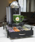 Vertuoline Coffee Pod Holder With Tempered Glass Drawer Deluxe Size Holds Up To 40 Pods For VertuoLine Capsules Keeps Your Countertop Organized And Clutter Free Boss Level Glass Drawer Organizer For Espresso Pods with machine and green mug on top.