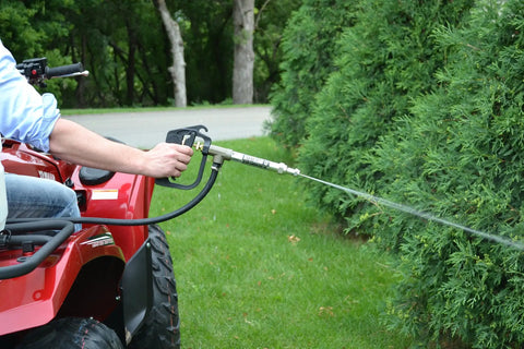 Person using Adjustable Aluminum Jet Stream Spray Gun With 13 Inch Reach 8 GPM At 900 PSI on outdoor bushes