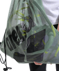 Mesh Pool Gear Sack For Swim Team Practice Quick Dry Tote Bag With Drawstring Closure Durable Polyester Swim Equipment Bag For Wet Gear Large 40 Liters Capacity Sage Green. Person holding bag filled with gear.