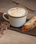 The Real Deal 4 Cup Steam Espresso System With Built In Frothing Arm For Rich Coffee And Creamy Lattes Easy Peasy Setup with latte and biscotti.