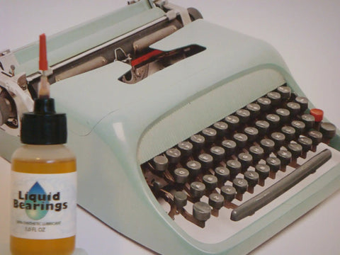 Typewriter Oil That Fixes Sticky Keys With 100 Percent Synthetic Formula, Delivers Smoother, Quieter Keys, Odor Free, Displaces Old Petro Oils, Quickly Clears Gunk, Includes 1/2 Inch and 1-1/2 Inch Needles For Easy, Mess Free Application, bottle with needle next to vintage typewriter