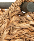 Close-up of Bankuan Braided Oval Toilet Paper Basket With Wood Bar showcasing woven wicker detail and wooden bar.