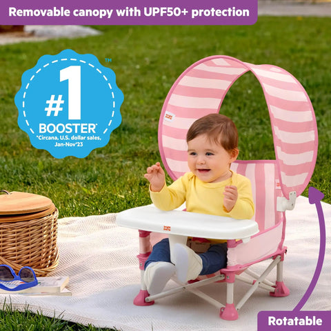 Pop N Sit Cabana Baby Beach Portable Booster Chair with UPF Canopy, pink, foldable, with removable tray, outdoors on grass.