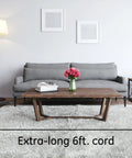 Grey sofa and coffee table in living room, highlighting 6-foot cord feature of 10 Outlet Surge Protector With 2 USB Ports, 3000 Joules.