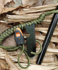 5 Inch Weatherproof Flint Ferro Rod Fire Starter Kit with whistle, paracord lanyard, and steel multitool striker on leaves