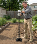 Heavy Duty Steel Garden Tamper With 48 Inch Handle And Rubber Grip For Soil Gravel Asphalt And Lawn in use in vegetable garden