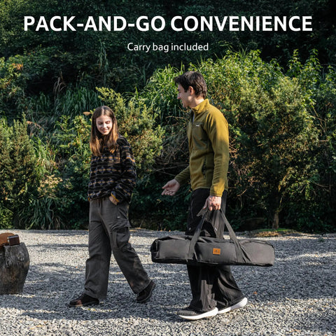 Two people carrying a folded Height Adjustable IGT Camping Table With Detachable Edge Mount For Extra Storage