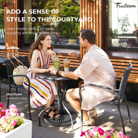 Outdoor couple enjoying drinks under a sunflower pattern umbrella base on patio