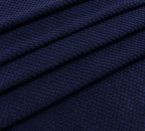 Close-up of navy blue waffle weave fabric from two pack navy blue pool lounge chair covers with waffle weave cotton terry towels.