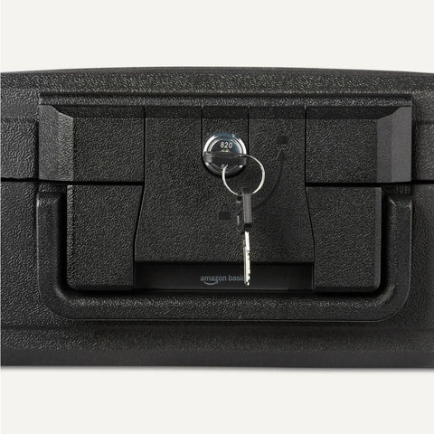Close-up of black fire resistant waterproof safe chest with mechanical key, 0.22 cu ft, showing lock and two keys.
