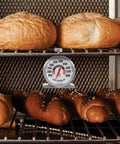Stainless Steel Oven Thermometer 150 to 600 F Leave-In Safe for Oven and Grill with pretzels and rolls, accurate temperature baking