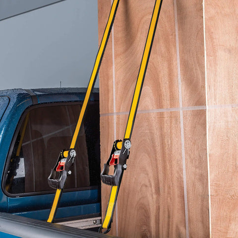 Heavy Duty Ratchet Tie Down Straps 4 Pack 16 Ft By 1.5 Inches securing plywood in a truck bed with rubber soft J hooks.