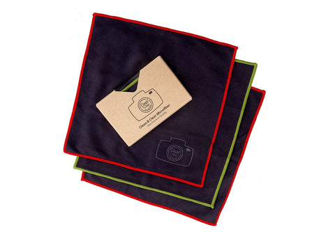 Microfiber cleaning cloths by Amazon, extra-large 8-pack, navy with red and green edges for cameras and screens.