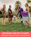 Two women and two men with a dog enjoying outdoors holding Director Style Outdoor Chair With Side Table And Armrest Caddy in park
