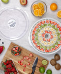 Smooth Operator Digital Electric Food Dehydrator With Stackable Trays, sliced fruits arranged on racks, strawberries, kiwi, and bananas.