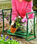 Person using Garden Kneeler And Seat Flip Bench For Comfortable Outdoor Gardening With Thick Foam Cushion Sturdy Lightweight Frame Handy Handles To Stand Up Easy Converts From Kneeler To Seat In Seconds For Cushioned Kneeling Or Sitting on garden path.