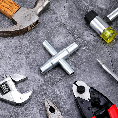 4 Way Sillcock Water Key Set 2 Pack Heavy Duty Steel Cross Wrench on concrete surface among various hand tools