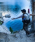 Person hiking with 48 Oz Wide Mouth Silo Water Bottle BPA Free Durable Leak Proof Large Capacity for Hiking on trail
