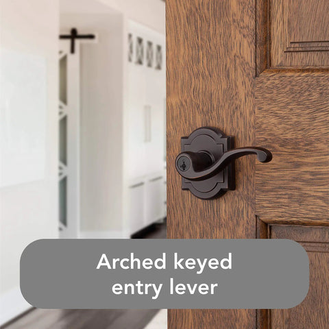 Entry Door Lever Handle With Keyed Lock And SmartKey Re-key Technology in Venetian Bronze on a wooden door