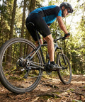 Cyclist riding mountain bike with 7/8 Speed Rear Derailleur Direct Mount For Mountain And Road Bikes Universal Replacement in forest trail