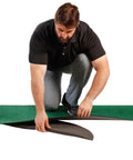 Man assembling Odyssey 10 Foot Indoor Putting Green Mat For Home Or Office Practice with Realistic Surface.