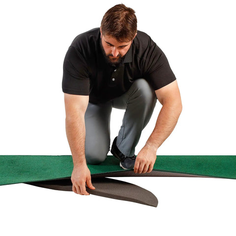 Man assembling Odyssey 10 Foot Indoor Putting Green Mat For Home Or Office Practice with Realistic Surface.