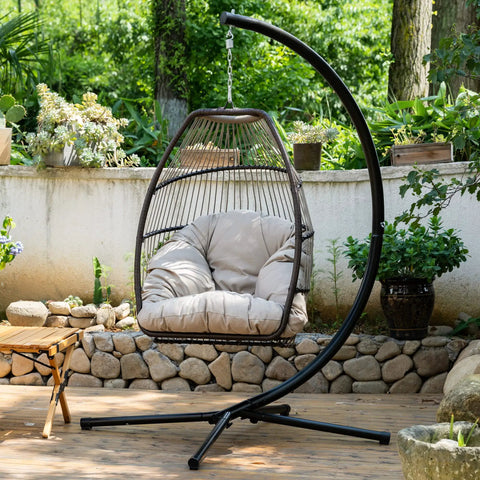 Cozy Outdoor Hanging Egg Chair With Stand And UV Resistant Cushion in garden setting, durable swing seat for relaxation.