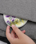 Person placing Watercolor Purple Flowers Wireless Charger 10W Fast Charging Pad Slim Portable Charging Station in bag pocket