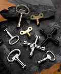 11 Piece Multi Functional Utility Key Kit for Plumbers and Home DIY Projects with 4 Way Keys on black stone surface