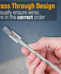 Hand holding RJ45 Cat6 Pass Through Connector with clear housing for easy wire identification and minimal noise in networking.