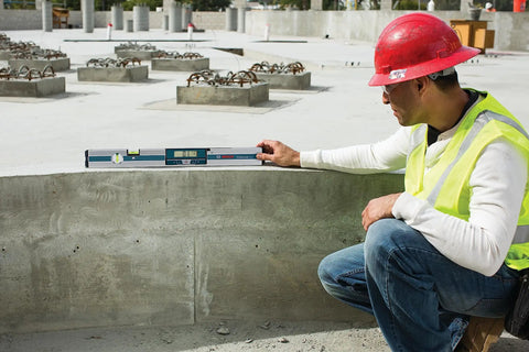 Worker using GIM 60 24 Inch Digital Level with Illuminated Rotating Display on construction site