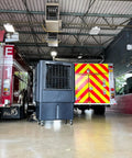 Industrial Swamp Cooler With 22000 CFM And 46 Gallon Water Tank delivers serious chill in a fire station garage with trucks.