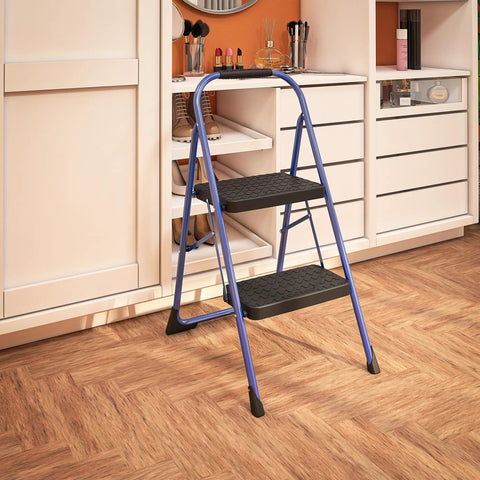 Two Step Steel Stool With Rubber Hand Grip In Blue For Home Use, Lightweight And Durable, in front of a cabinet in a room