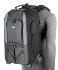 Streetwalker Rolling Camera Backpack With Dedicated Laptop Pocket And Minimalist Black Exterior, Hidden Zip Opening For Main Compartment When Not In Use, Durable, Travel Ready For Photographers On The Go, displayed on a mannequin