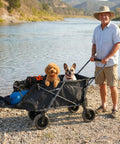 Man with dogs using Beefy Heavy Duty Folding Dog Wagon Cart With Extendable Rear by river, 220L capacity black cart with gear