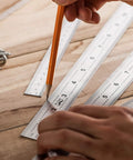 Person using Beefy Machinist Ruler Set Four Pack Stainless Steel With Six Eight Twelve And Fourteen Inch Lengths In Metric Gradations.