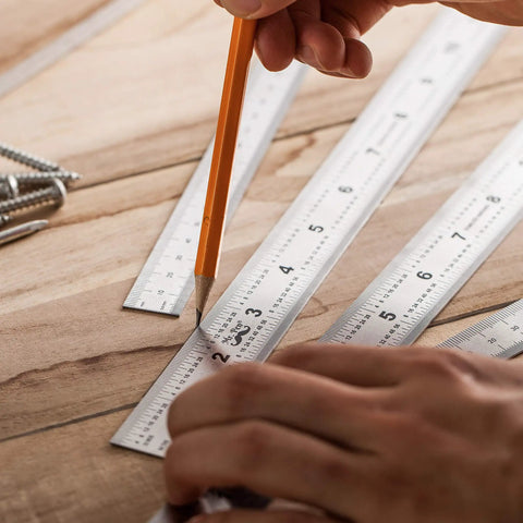 Person using Beefy Machinist Ruler Set Four Pack Stainless Steel With Six Eight Twelve And Fourteen Inch Lengths In Metric Gradations.