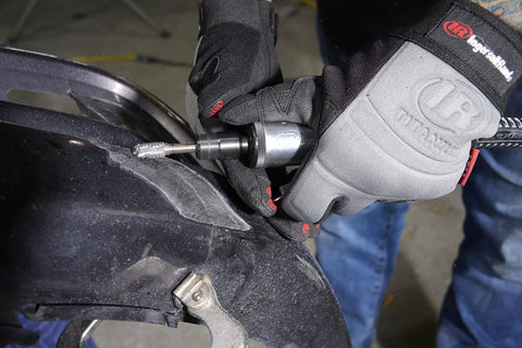 One Quarter Inch Air Die Grinder With Straight Head Design being used for grinding on a vehicle part