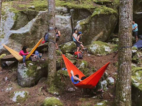 Outdoor scene with campers using Roo Double Hammock With GravitasX Water Resistant Breathable Ripstop Fabric in a forest setting.