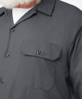 Men's Long Sleeve Work Shirt Charcoal Relaxed Fit Button Front With Twin Chest Pockets Built Like A Tank Cotton Poly Blend Wrinkle Resistant Finish For The Daily Grind close-up showing button flap pockets and shirt texture.