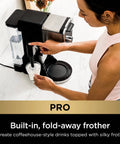 Woman using Hot And Iced Coffee Maker With All In One Dual Brew Pro System For Single Serve Or Drip Brew, 13 Brew Sizes, frothing milk